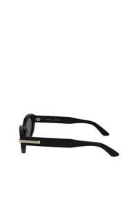Black sunglasses featuring a rounded frame, sleek black temple arms, and a metallic accent on the side. Textured finish with dark lenses.