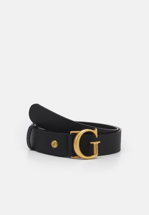 Ceinture en cuir noir texturé avec une grande boucle dorée en forme de lettre G et un petit bouton rond doré avec logo près de la boucle.