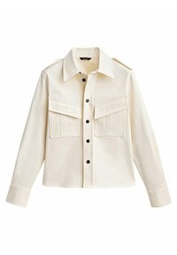 Chemise boutonnée crème avec un col, deux poches poitrine, boutons noirs et un ourlet court. Fabriquée dans un tissu lisse avec une coupe structurée.