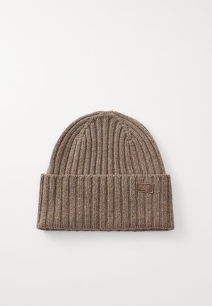 Brown ribbed knit beanie with a foldable cuff and a small rectangular brand tag sewn on the front. Soft texture with a snug fit.