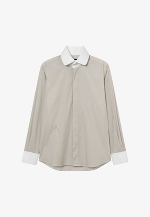 Beżowa koszula z długim rękawem, białym ostrym kołnierzykiem i białymi mankietami, z ukrytą listwą na guziki oraz subtelnym haftem na przodzie.