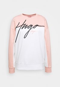 Sweatshirt met roze mouwen en bovenste gedeelte, witte body en grote zwarte en kleinere roze Hugo logo tekst over de borst.