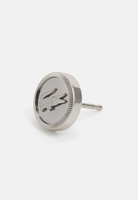 Sølv metall mansjettknapper med et hevet krokodillelogo, rund form med ribbet kant, polert finish og en solid stift for festing.
