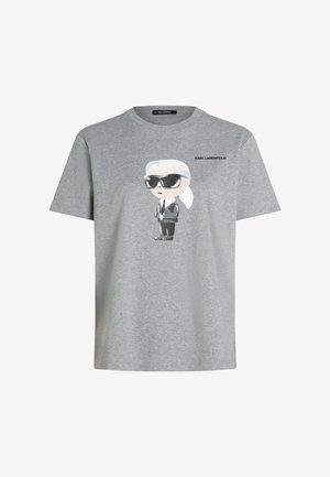 Halli puuvillane T-särk, millel on musta ülikonna ja päikeseprillidega joonistatud multifilmikujutis ning kujutise kohal tekst "KARL LAGERFELD".