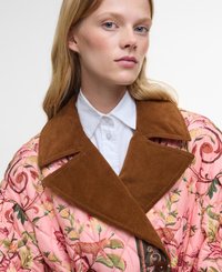 Quilted pink jacket with floral patterns, brown corduroy collar, and a button closure. Features animal prints and a glossy finish.