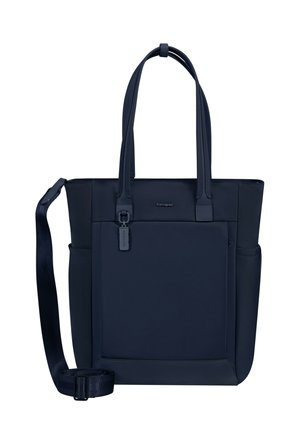 Dark blue tote bag with dual handles, adjustable shoulder strap, front zip pocket, and small logo detail.