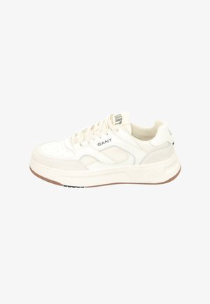 White sneaker with a textured upper blending leather and mesh. Thick rubber sole, round toe, and brand logo prominently displayed.