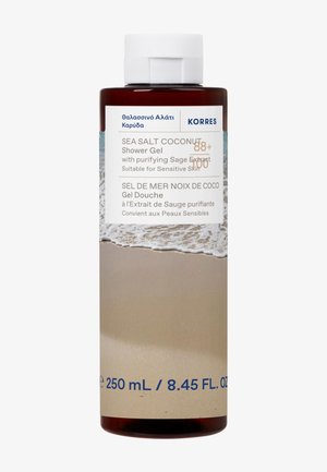 Braune Kunststoffflasche mit Korres Sea Salt Coconut Duschgel, ausgestattet mit einem weißen Deckel, blauer Schrift und einem Etikett mit einer Strandszene am Boden.