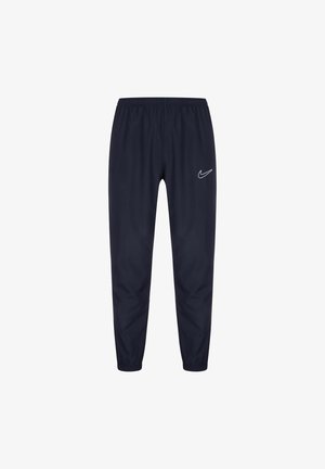 Pantalon de sport bleu marine avec taille et poignets élastiques, arborant un logo blanc Nike swoosh sur la cuisse gauche.