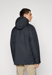 Dark, insulated jacket with a hood, featuring a smooth texture and a seam across the back. Simple design, suitable for cold weather.