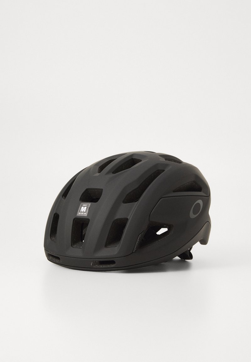 Black bicycle helmet with multiple ventilation slots, sleek design, adjustable fit, and a size label indicating medium (54-58 cm).