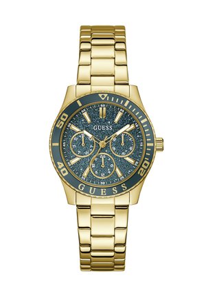Ρολόι χειρός Guess με χρυσή απόχρωση, καντράν σκούρο μπλε με γκλίτερ, τρεις υποκαντράν, φωσφορίζοντες δείκτες και βραχιόλι από μεταλλικούς κρίκους στον ίδιο τόνο.