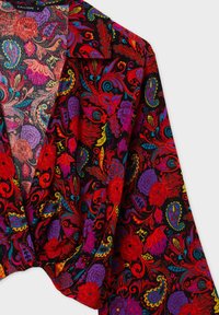 Top avvolgente floreale multicolore caratterizzato da motivi vivaci in rosso, viola e turchese su uno sfondo nero. Tessuto morbido con una vestibilità rilassata.