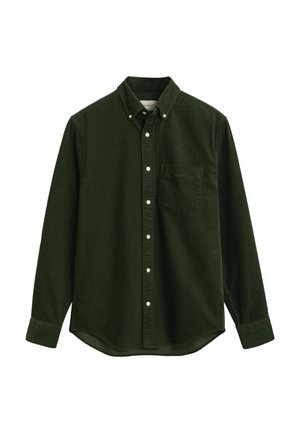 Chemise en velours côtelé vert foncé avec manches longues, boutonnière à l'avant, col rabattu et une poche poitrine unique. Tissu texturé avec un léger ridage.
