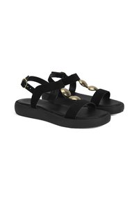 Schwarze Wildledersandalen mit dicker Sohle, ausgestattet mit verstellbaren Riemen und metallic-akzenten an der Oberseite für zusätzliche Details.