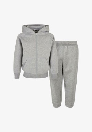 Hanorac gri din bumbac cu fermoar și buzunare laterale, asortat cu pantaloni de trening care au talie elastică și glezne taperate.