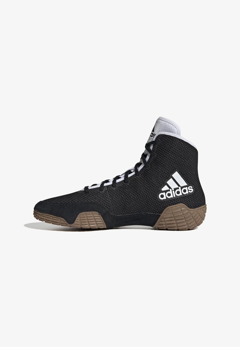 Svart träningsskor med hög skaftdesign, mesh-överdel, vita accenter och en texturerad gummisula. Har snörningssystem och Adidas-logotyp.