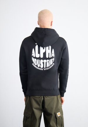 Black hoodie with a large white circular logo reading "ALPHA INDUSTRIES" on the back. Features a drawstring hood and ribbed cuffs.