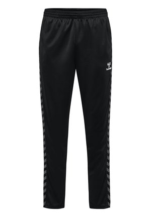Zwarte sportbroek gemaakt van gladde stof, met een elastische tailleband en contrasterende chevrons aan de zijkanten. Logo's zichtbaar aan de voorkant.