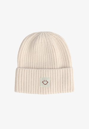 Beanie a coste di un leggero beige con risvolto e un'etichetta quadrata con un design di faccia sorridente. Texture morbida con una vestibilità aderente.