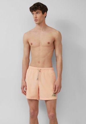 Kratke plavuše boje za plivanje s elastičnom waistband, zatvaranjem na vezanje i malim logotipom na donjoj lijevoj strani.