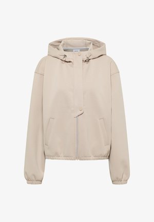 Veste à capuche beige en tissu doux avec fermeture éclair à l'avant, poignets élastiqués et deux poches latérales. Présente des détails de design minimalistes.