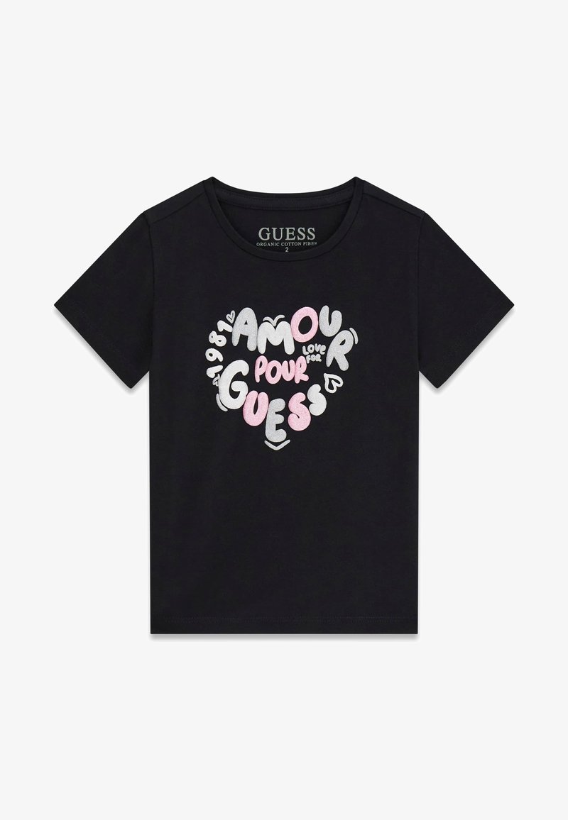 T-shirt nera in cotone biologico con design a cuore e scritta "AMOUR POUR GUESS" in bianco, argento e rosa, maniche corte e scollo rotondo.