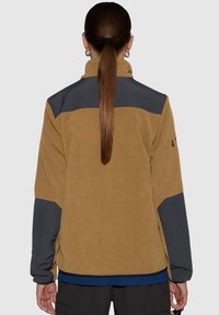 Brown fleece jacket with dark gray shoulders, relaxed fit, long sleeves, and a high collar. Features textured fabric and elastic cuffs.