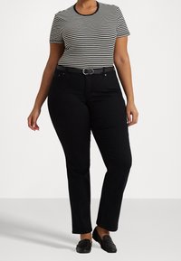 Black straight-leg jeans with a fitted waist and belt loops, paired with a black and white striped short-sleeve top. Smooth fabric texture.