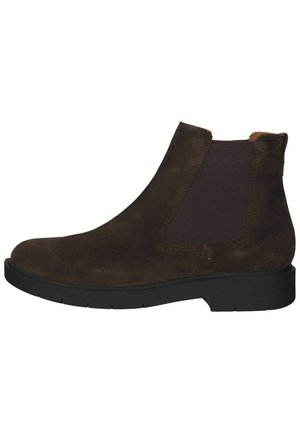 Stivale alla caviglia in suede marrone con pannelli laterali in elastico, punta arrotondata e suola in gomma piatta. Cuciture dettagliate lungo i bordi.