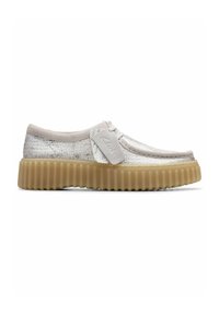 Silver mesh sneakers with a rounded toe, cream-colored rubber sole, and a textured upper. Features a lace closure and branding detail.