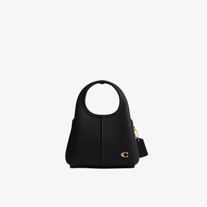 Petit sac à main en cuir noir avec poignée arrondie, fermoir doré et étiquette attachée sur fond blanc.
