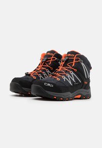 Black hiking boots with orange accents, waterproof material, textured surface, and a rugged sole. Features secure lace system and brand logo.