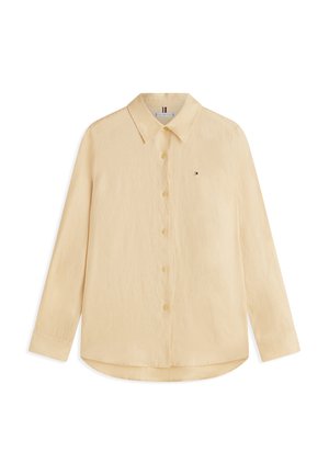 Μπεζ πουκάμισο με μακριά μανίκια, κουμπιά, γιακά και μικρό κεντημένο λογότυπο στην αριστερή πλευρά του στήθους.