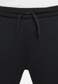 Schwarze Sporthosen mit einem strukturierten Bund und Kordelzug sowie glattem Stoff. Entwickelt für Komfort mit einer taillierten Silhouette.