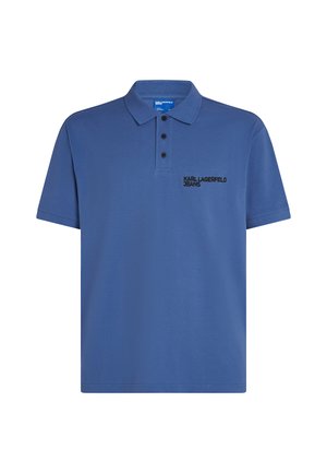 Mėlynas polo marškinėliai, pagaminti iš minkštos medžiagos, su trimis mygtukais ir juodu išsiuvinėtu logotipu kairiajame krūtinės pusėje. Trumpomis rankovėmis, laisvas fasonas.