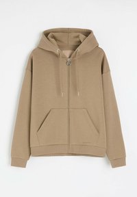 Brązowy, zapinany na zamek dresowy kaptur wykonany z miękkiego materiału. Posiada kaptur, kieszenie z przodu oraz ściągacze przy mankietach. Minimalistyczny design bez widocznych wzorów.