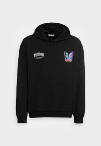 Sweat à capuche noir en coton avec une poche avant. Présente un motif de papillon en bleu et violet, ainsi que le texte "LIBERTÉ" sur la poitrine gauche.