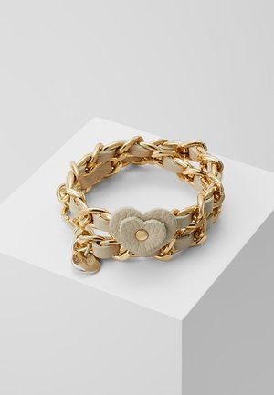 Bransoletka z łańcuszka ze złota spleciona z beżową skórą, z zapięciem w kształcie serca o strukturze beżowej oraz małą złotą zawieszką.