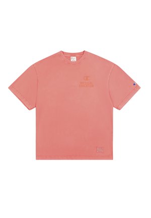 Pink cotton t-shirt with short sleeves, crew neck, and a logo print. Notable accents include a patch on the lower left side.