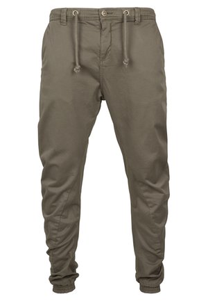 Pantalones jogger en color caqui, fabricados en tejido ligero, con cinturilla elástica y cordones, bolsillos laterales y piernas ajustadas con puños.