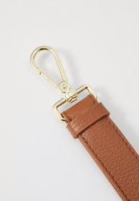 Brown leather strap with a textured finish, featuring a gold metal lobster clip and buckle detail.