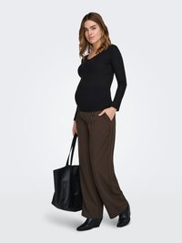 Long-sleeve black ribbed top, brown wide-leg pants, black tote bag, and black wedge boots. Model has loose waves and a pregnant silhouette.