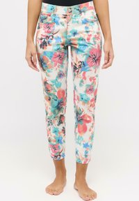 Pantaloni floreali con un pattern brillante e multicolore, caratterizzati da grandi fiori rosa e blu. Realizzati in un tessuto morbido, hanno un design a cropped con una vestibilità slim.