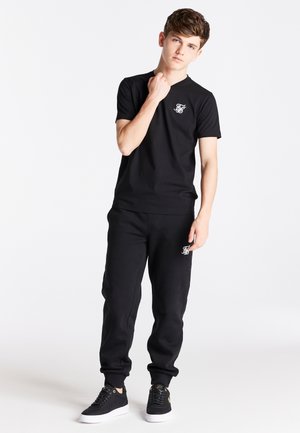 CUFFED - Pantaloni sportivi - black