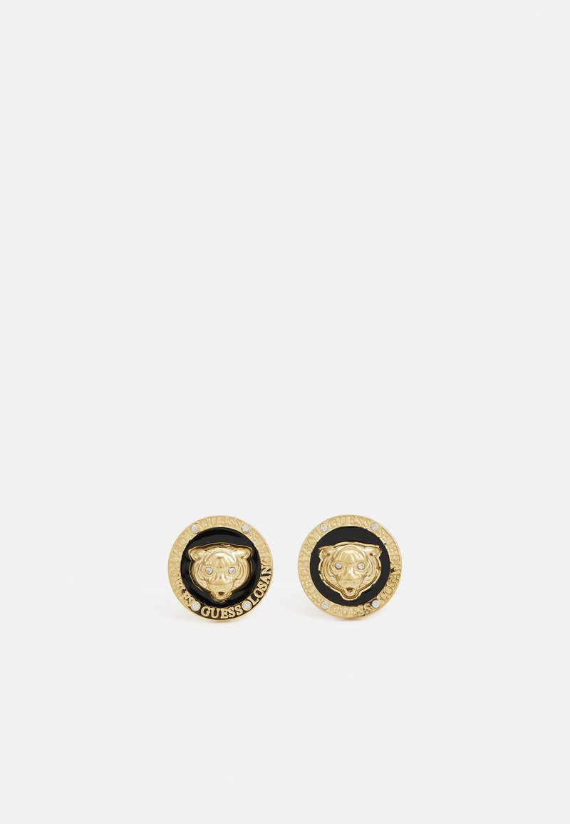 Gold-tone stud earrings featuring a raised tiger head design, surrounded by a contrasting black circle and embossed brand text.