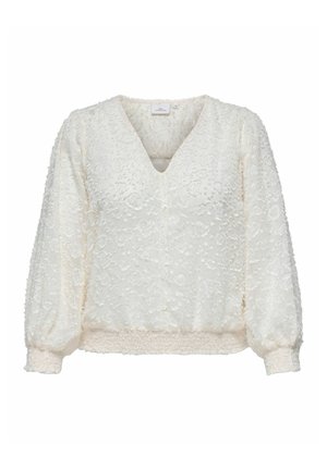 Hvid bluse med tekstureret blomstermønster, V-udskæring og puffede ærmer. Har en samlet talje og diskrete knapdetaljer.