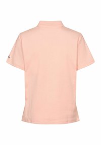 Svetloružová polo tričko s krátkym rukávom, s rebrovanou štruktúrou a klasickým golierom. Obsahuje malý znakový detail na ľavom rukáve.