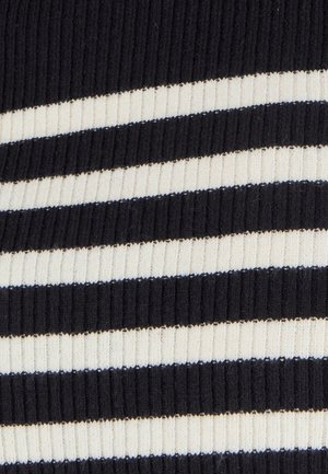 Tissu en tricot à rayures noires et crème avec une texture côtelée. Des rayures épaisses et fines alternées créent un motif géométrique.