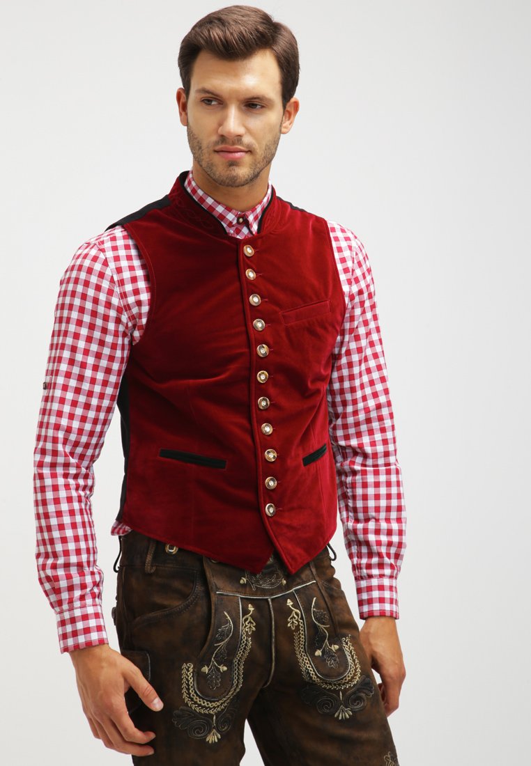 Red velvet waistcoat with a high collar, featuring silver buttons and black accents, paired with a red and white checked shirt and brown trousers.